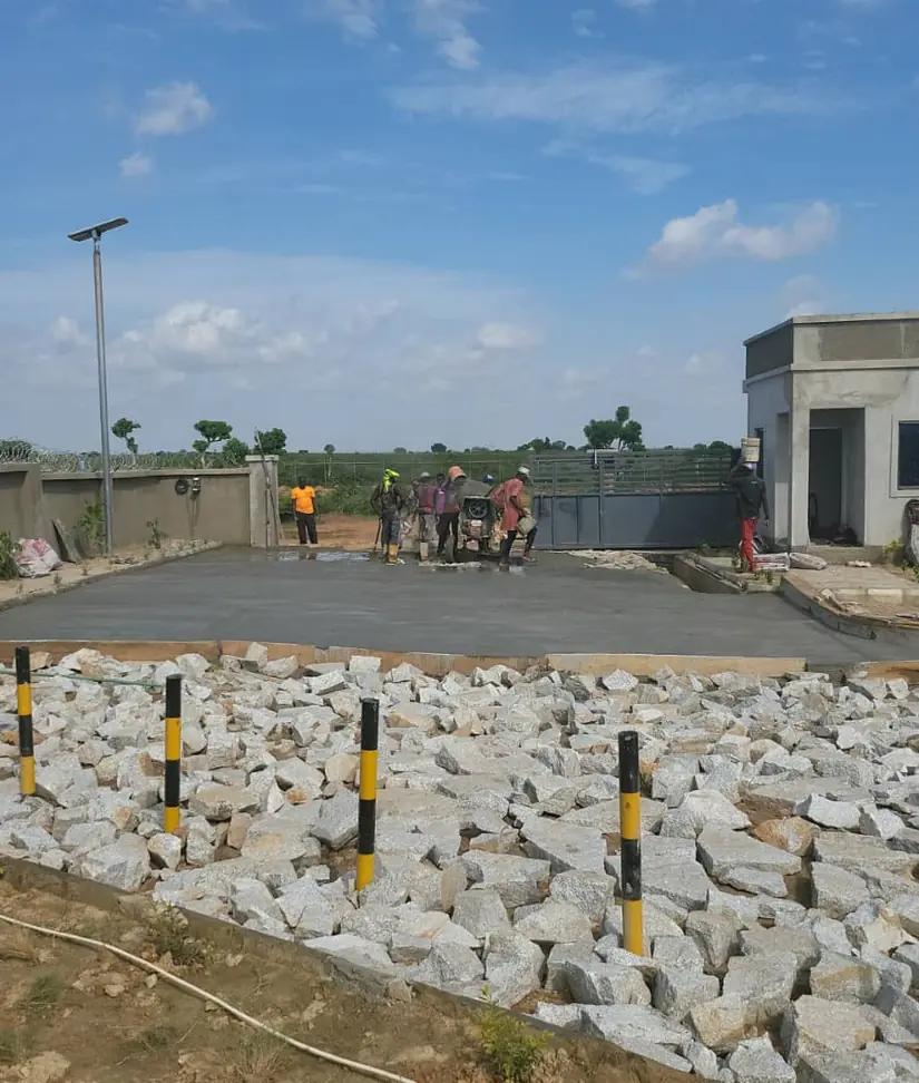 Workers laying concrete hardstanding at the facility entrance
